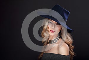 Glamour makeup blond long hair woman posing in fashion hat