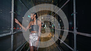 Glamour model strolling night town portrait. Brown skin chick woman walking city