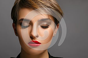Glamour portrait of a beautiful lady with short hair and proffessional make up. photo
