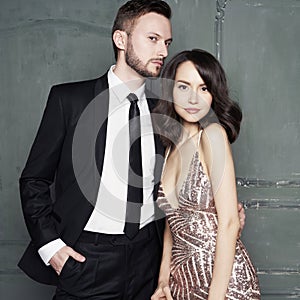 Glamour portrait of sexy young lovers. Fashionable elegant man and woman