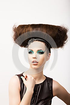Glamour. Vitality. Portrait of Unusual Brunette with Extraordinary Festive Hairdo