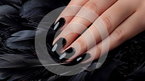 Glamour woman hand with luxury black color nail polish manicure on fingers, touching rainbow feathers