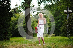 glamour woman with a red rose. Outdoor summer picture