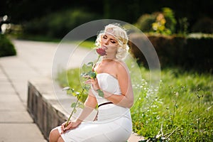 glamour woman with a red rose. Outdoor summer picture