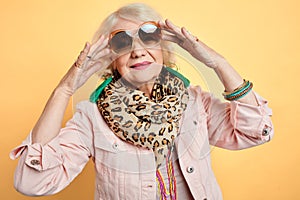 Glamour woman in stylish sunglasses posing to the camera