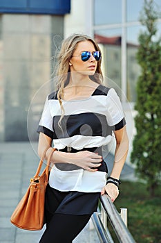 Glamourous portrait of the young beautiful woman in sunglasses photo