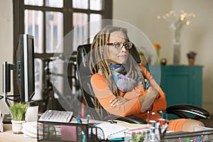 Skeptical Woman with Drealocks at Her Desk