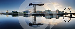 Glasgow Cityscape at sunrise, skyline panorama with reflecion in river with sun, Scotland - UK