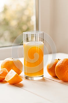 Glass of 100% Orange juice with pulp and sliced fruits isolate on white background.Be cut to remove the orange juice to drink and