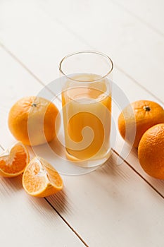 Glass of 100% Orange juice with pulp and sliced fruits isolate on white background.Be cut to remove the orange juice to drink and