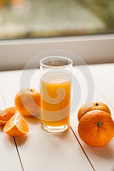 Glass of 100% Orange juice with pulp and sliced fruits isolate on white background.Be cut to remove the orange juice to drink and