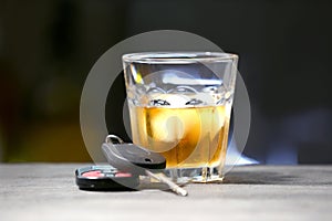 Glass with alcohol and car keys
