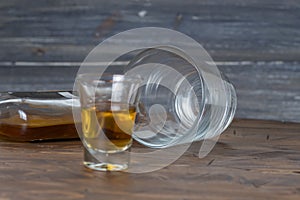 A glass of alcohol on wooden
