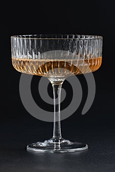 Glass with alcoholic drink on a black background