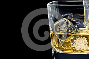 Glass of alcoholic drink on black background