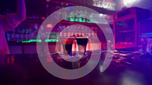Glass of Alcoholic Drink on Fire on a Bar Counter Close-up in a Nightclub
