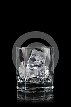 Glass for alcoholic drinks with cun ice on black