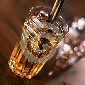 Glass of alkohol drink on wooden table