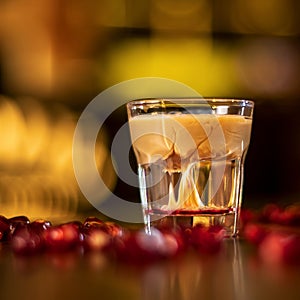 Glass with alkohol shot on wooden table