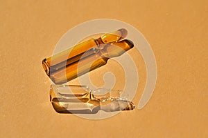 Glass ampoules on a beige orange background.