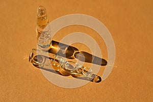 Glass ampoules on a beige orange background.