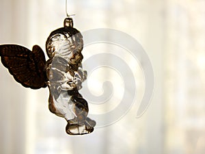 Glass Angel in front of Window