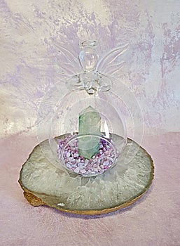Glass angel heart with aventurine natural crystal on quartz slice photo
