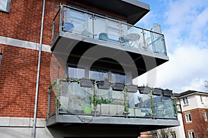 Glass apartment balconies used as garden space in town centre