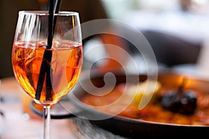 Glass of aperol spritz cocktail long drink close up, summer fresh appetizer, evening meal, dinner
