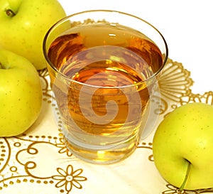 glass of apple juice and fresh apples on white