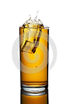 A glass of apple juice on a white isolated background