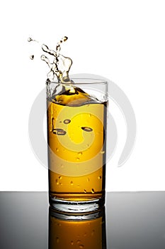 A glass of apple juice on a white isolated background