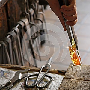 Glass Artist in her workshop making glassware