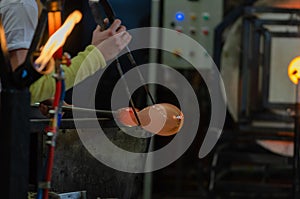 Glass Artist in her workshop making glassware