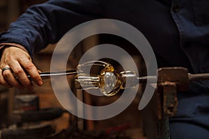 Glass Artist in her workshop making glassware