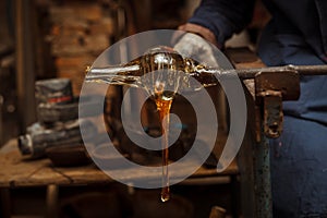 Glass Artist in her workshop making glassware