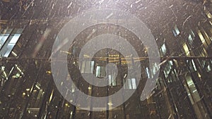 glass atrium of a business center during heavy snowfall at night in St. Petersburg, Russia