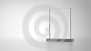 Glass award with metal base isolated on gray background.