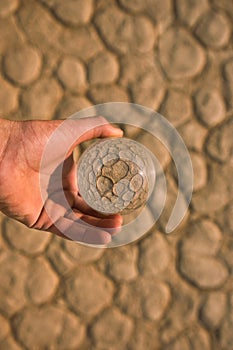A glass ball above clay ground
