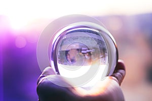 Glass ball on hand on mistery background