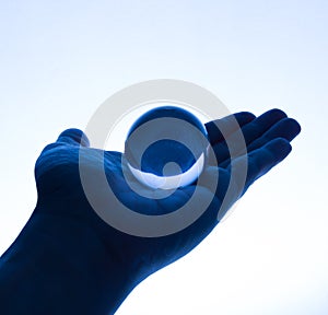 Glass Ball on Hand in Tungsten Light