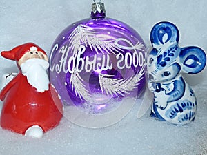 Glass ball with the inscription in Russian `Happy New Year`, Santa Claus and symbol of the New Year 2020 is a white rat mouse