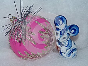 Glass ball and symbol of the New Year 2020 is a white rat mouse according to the eastern calendar. New Year`s toys.
