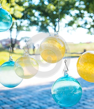 Glass balls hanging from fish hooks