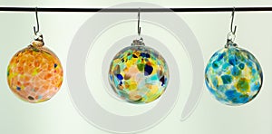 Glass baubles.  Three hand blown glass Christmas tree ornament in clear translucent multicolour