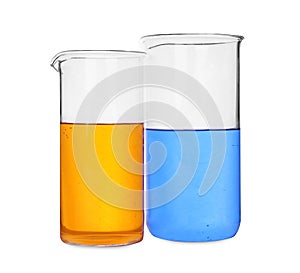 Glass beakers with colorful liquids on white background