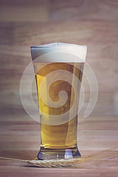 Glass beer and bale on wood background