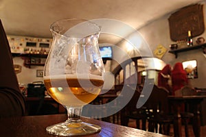 Glass with beer in bar photo