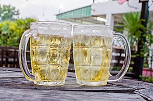 Glass of beer with bar scene in the background