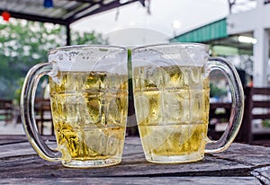 Glass of beer with bar scene in the background